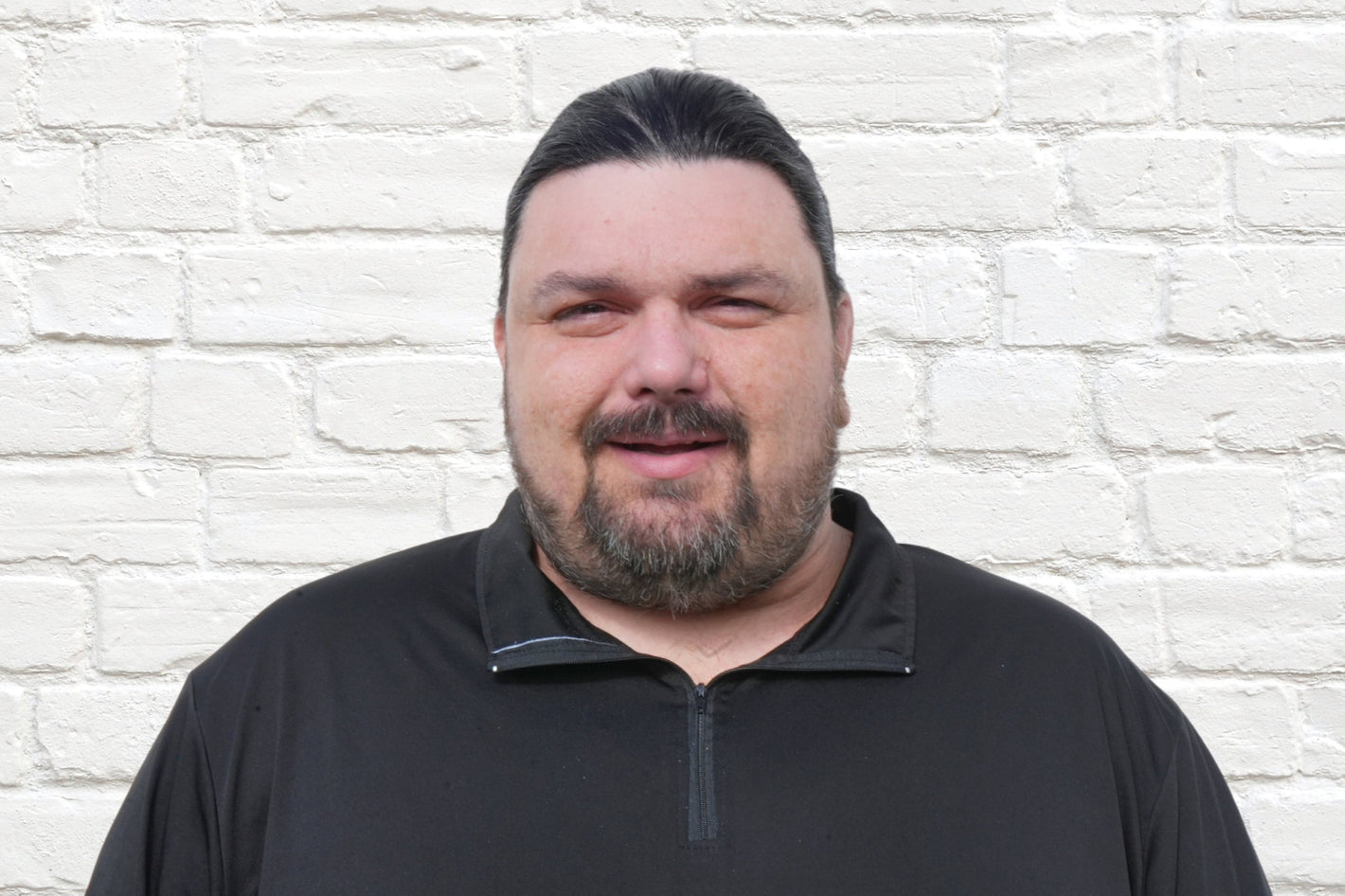 Billy, Operations Team member of leading wholesale liquidation company in the United States, Zapps Wholesale, poses in North Carolina warehouse.