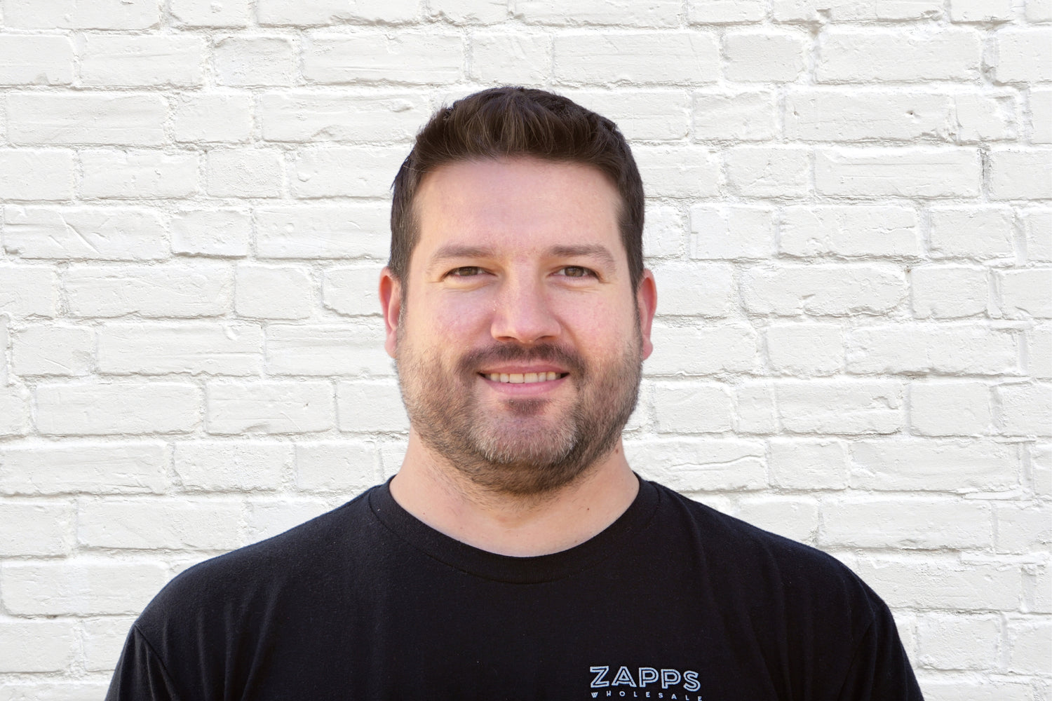 Brian, Sales Director of leading wholesale liquidation company in the United States, Zapps Wholesale, poses in North Carolina warehouse.