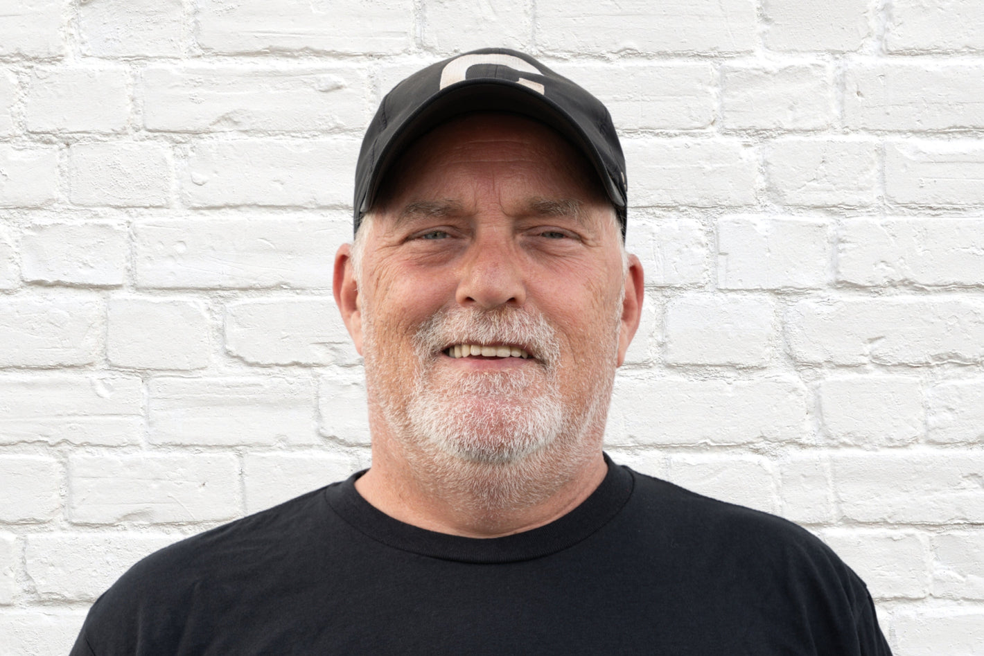 Bruce, Operations Team member of leading wholesale liquidation company in the United States, Zapps Wholesale, poses in North Carolina warehouse.